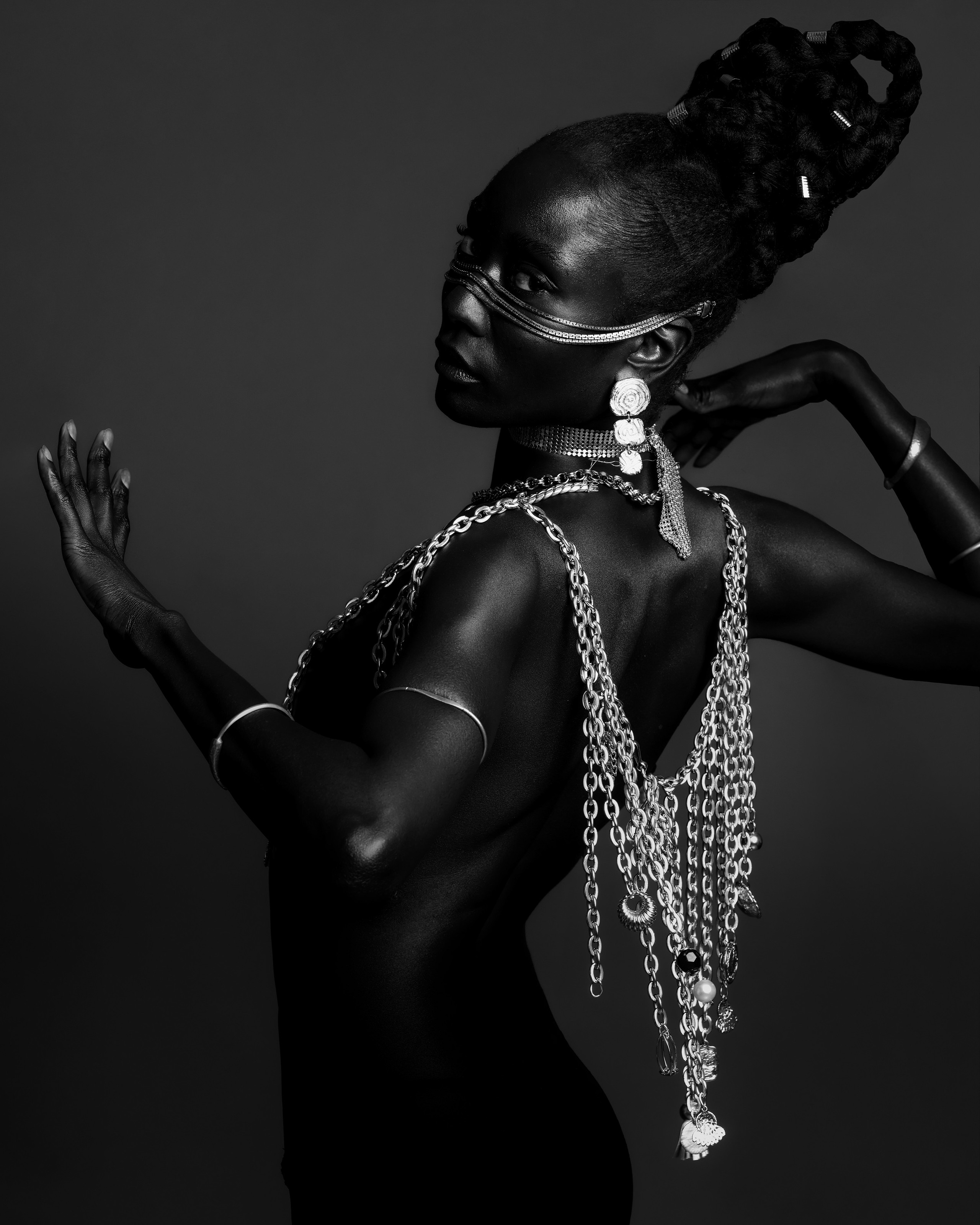 Monochrome beauty portrait styled with metallic chains