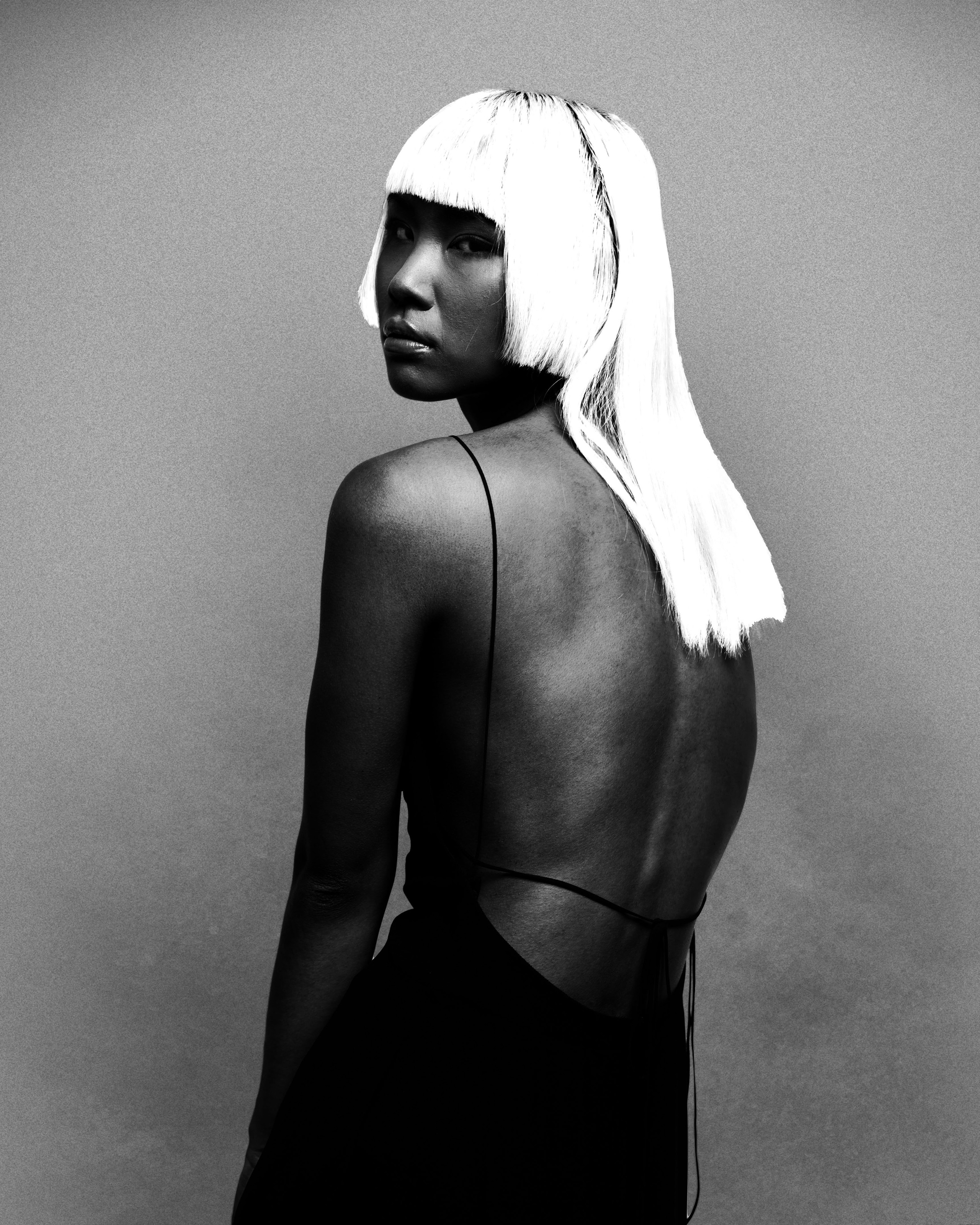 Black and white fashion portrait with a graphic white bob