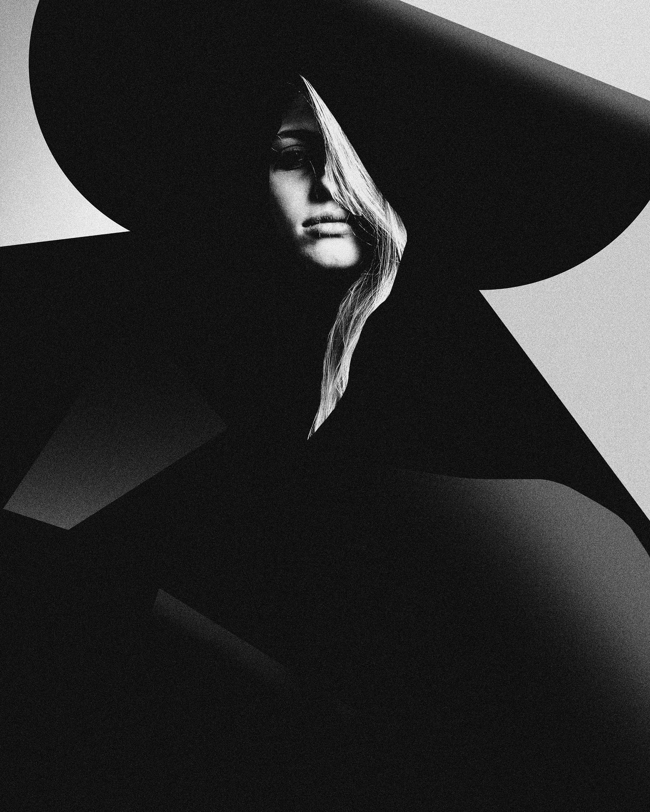 Graphic black and white portrait with sculptural millinery